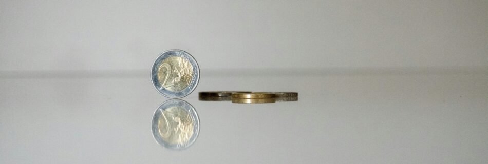 a gold ring with a coin on top of it